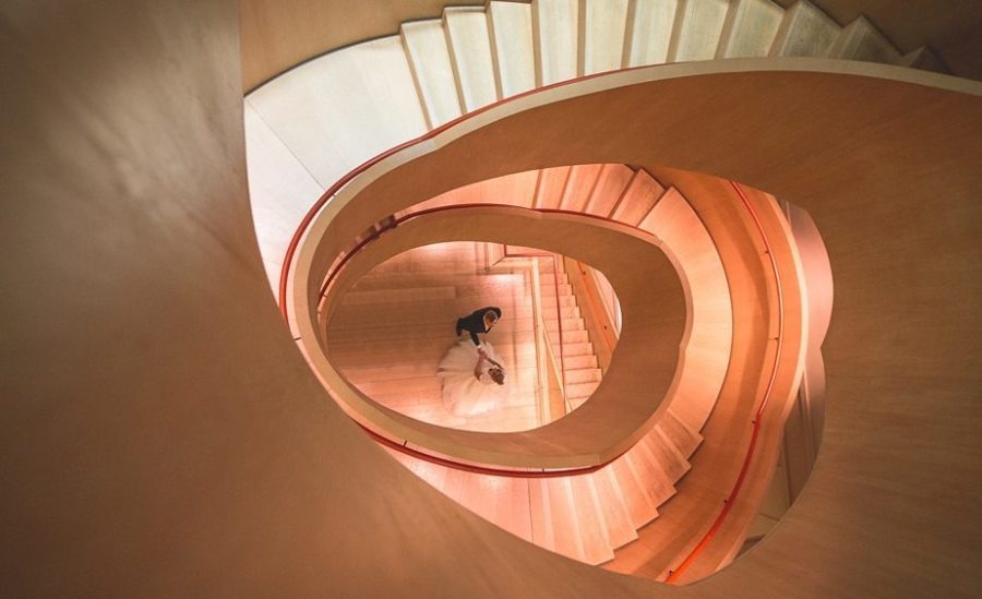 Birde and Groom dancing at the winding staircase of Coworth park