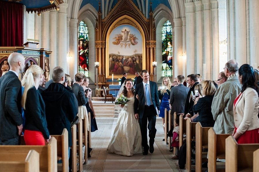 Bride and groom walking out of the church at Copenhagen winter destination wedding