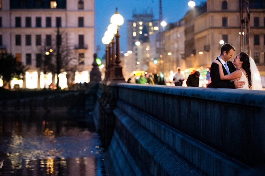 Copenhagen wedding photographer bride and groom standing on the bridge at their winter wedding