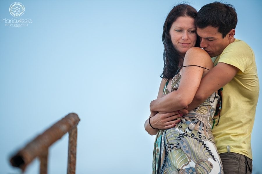 A man kissing his fiancé's shoulder on their Black Sea Evening pre wedding shoot destination wedding photographer