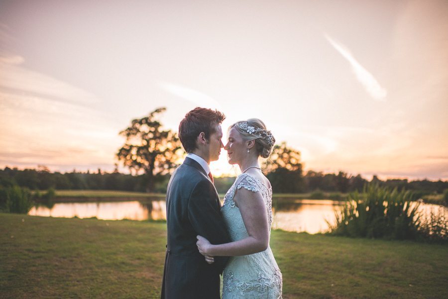 Coworth park's breathtaking couple shoot location at the lake at sunset