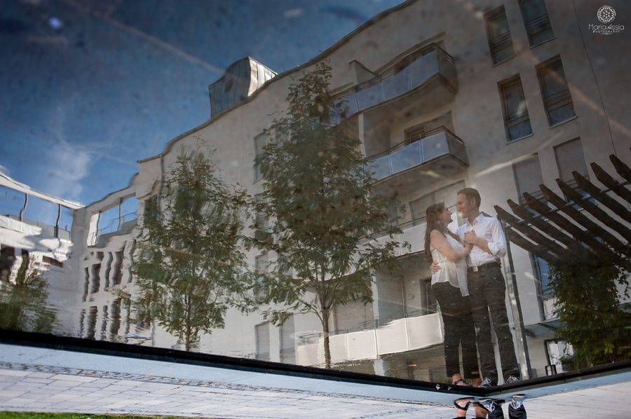 Engaged couple reflected in the pool