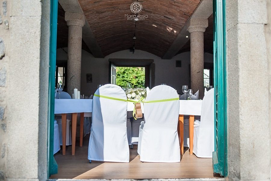 Bride and Groom's chairs tied together bathed in sunshine