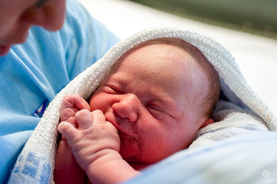 newborn baby held by his dad for the first time