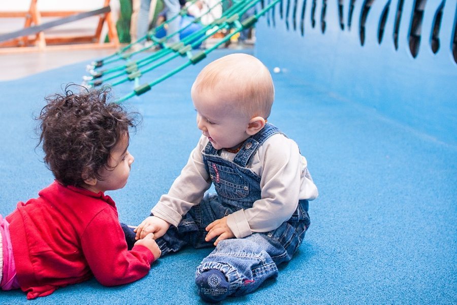 two toddlers playing together on the playground