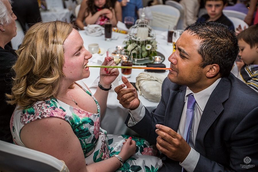 Wedding guests sharing a candy snake at a Billesley Manor Hotel Fuchsia Spring Wedding