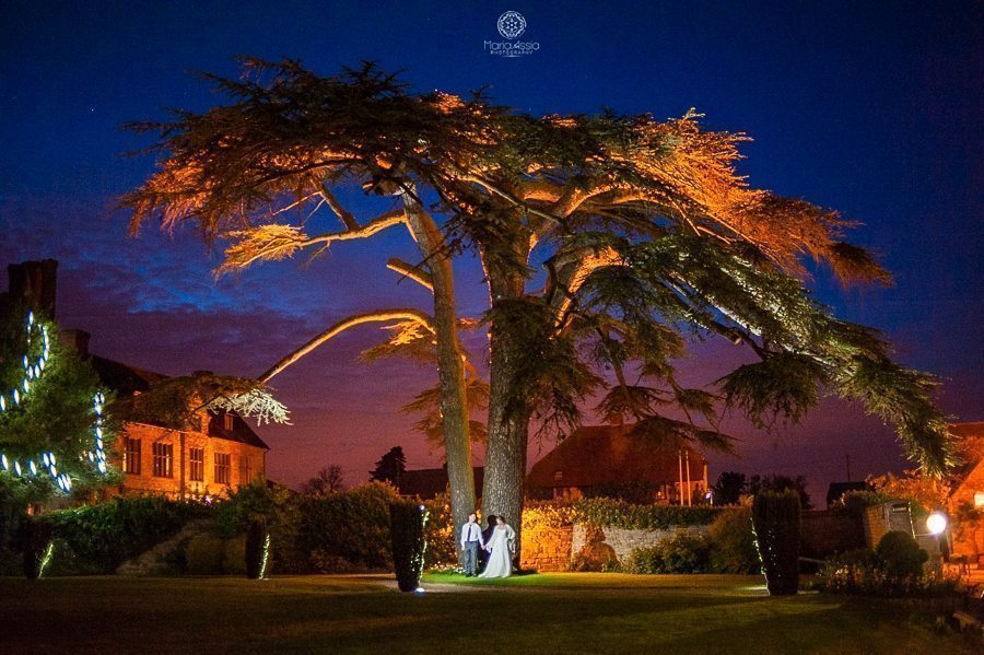 Bride and groom night time portrait at their Billesley Manor Hotel Fuchsia Spring Wedding low light wedding portrait