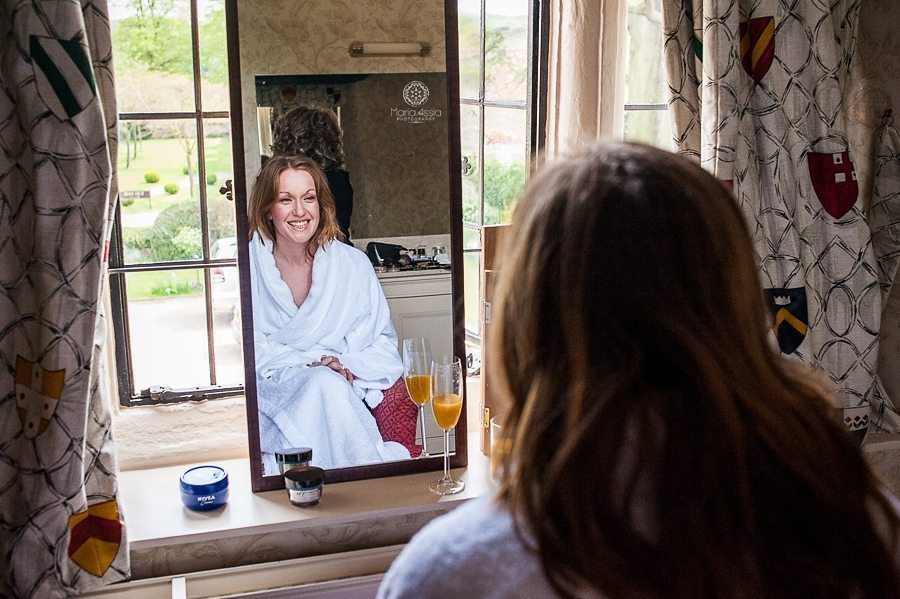 Bride getting ready for her Billesley Manor Hotel Fuchsia Spring Wedding