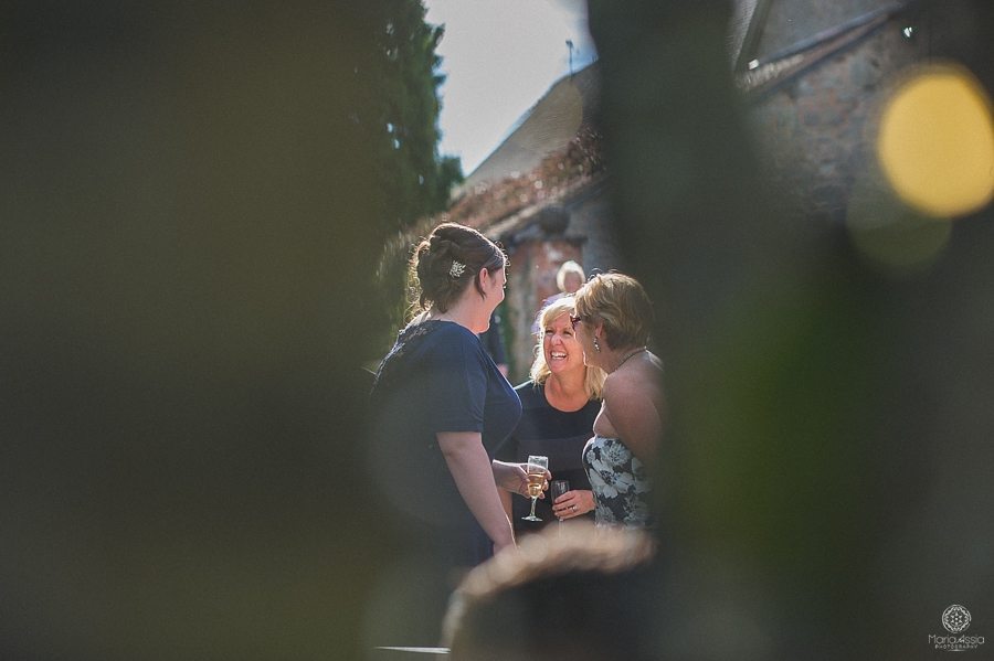 Bride chatting with wedding guests at Birtsmorton Court wedding