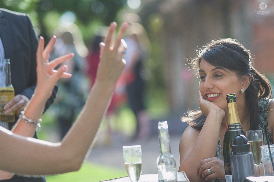 Chatting wedding guests at a Birtsmorton Court Navy Blue Wedding - Maria Assia Photography