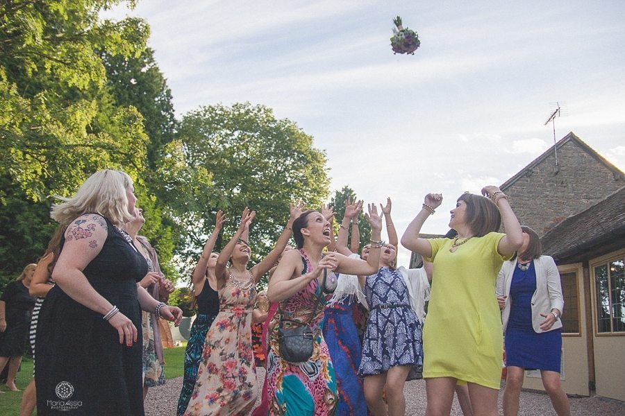 Girls catching the bride's flowers at a Birtsmorton Court Navy Blue Wedding - Maria Assia Photography