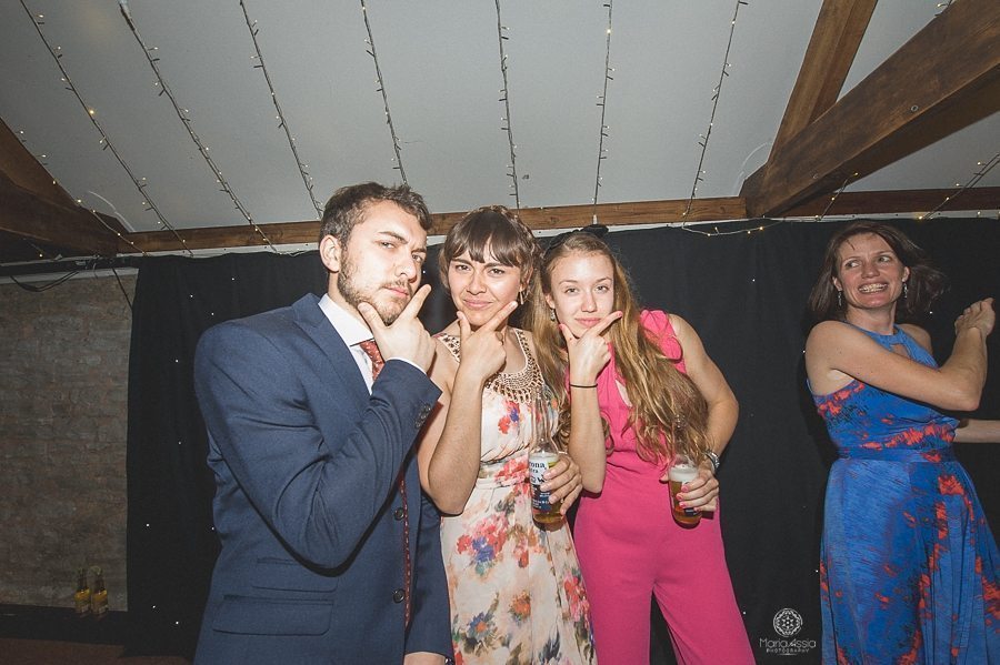 wedding guests pulling faces at a Birtsmorton Court Navy Blue Wedding - Maria Assia Photography