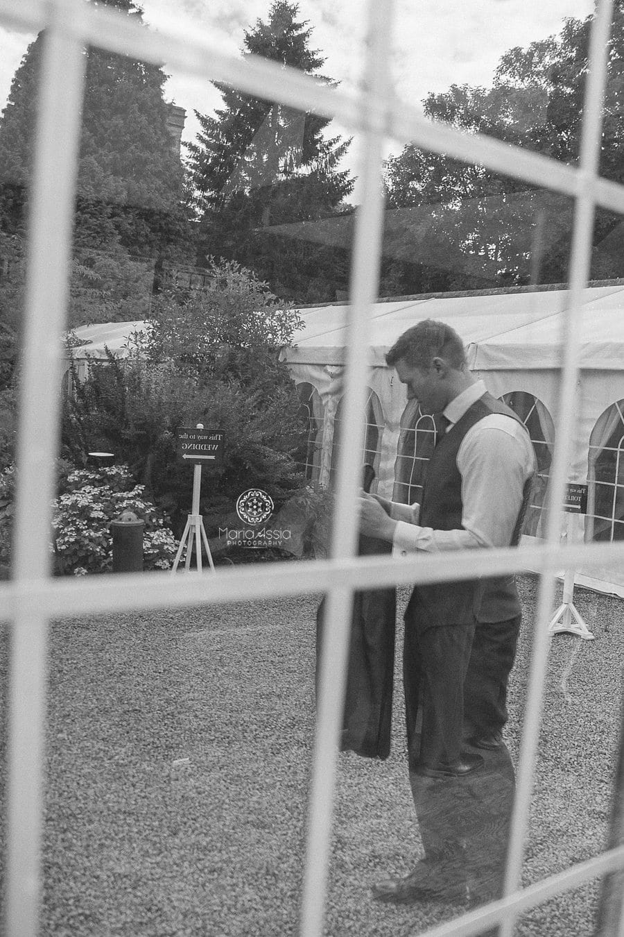 Groom reflecting in the mirror at Birtsmorton Court Navy Blue Wedding