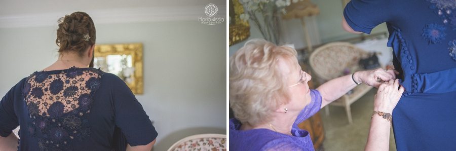 Bride putting on her dress for her Birtsmorton Court Navy Blue Wedding - Maria Assia Photography