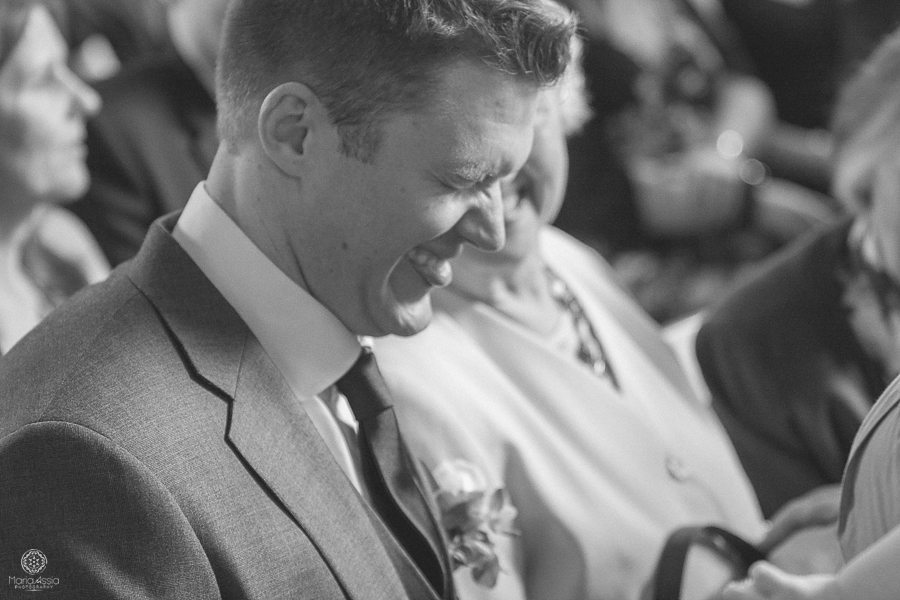 laughing groom at Birtsmorton Court Navy Blue Wedding - Maria Assia Photography