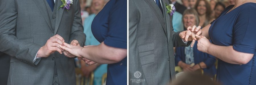 Bride and groom exchanging rings at their Birtsmorton Court Navy Blue Wedding - Maria Assia Photography