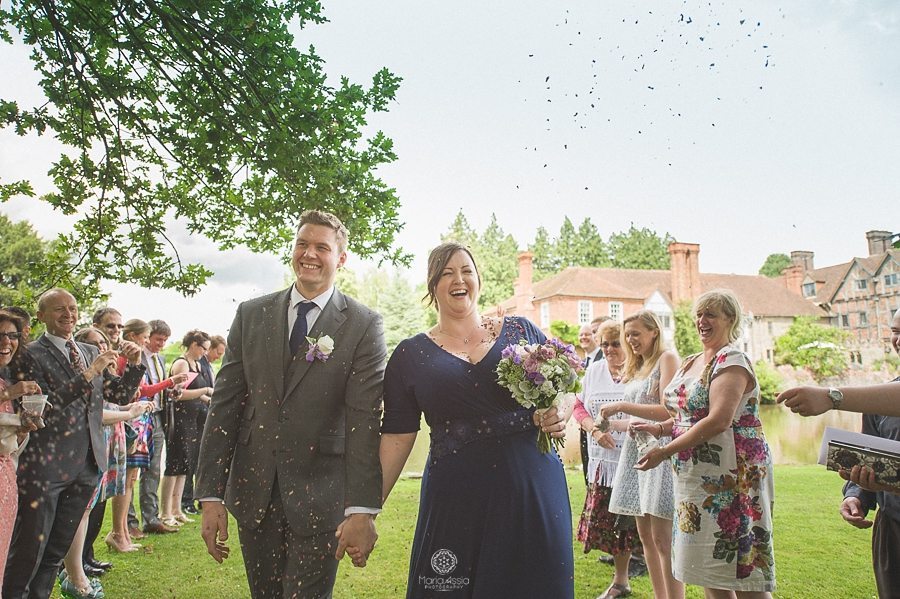 Bride and Groom walking through confetti at Birtsmorton Court