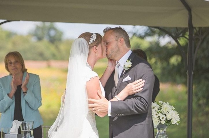 Bride and groom kissing at their wedding ceremony