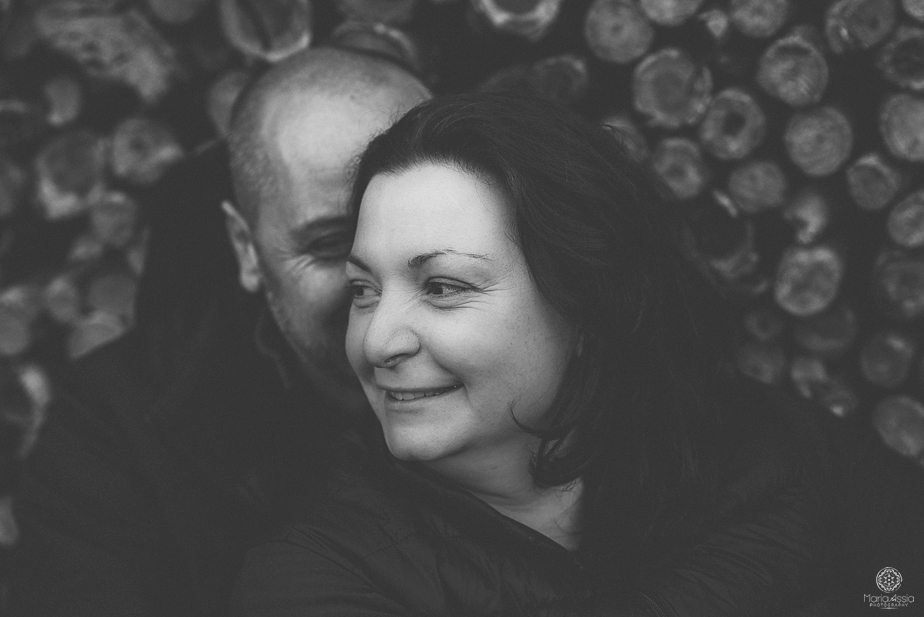 A man kissing a girl on the cheek at their Black Forest evening low light couple shoot