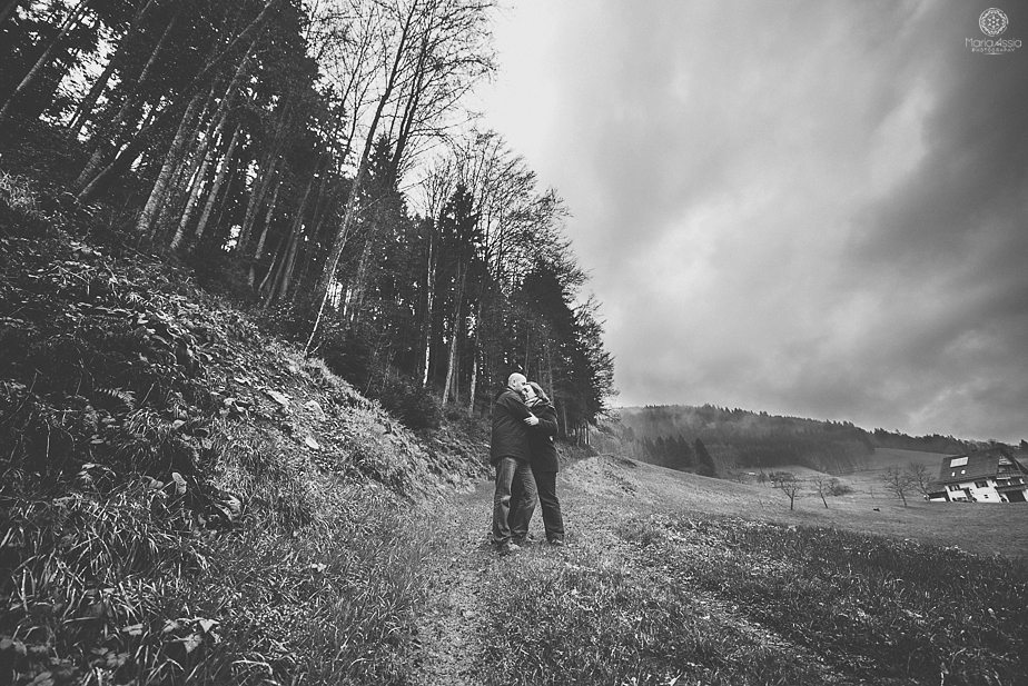 Couple standing on a woodland path in the Black Forest mountains by destination wedding photographer Maria Assia Photography