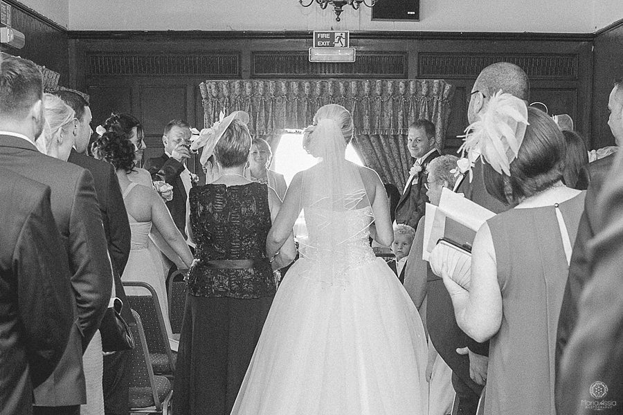 Groom's face as his bride walks down the aisle towards him