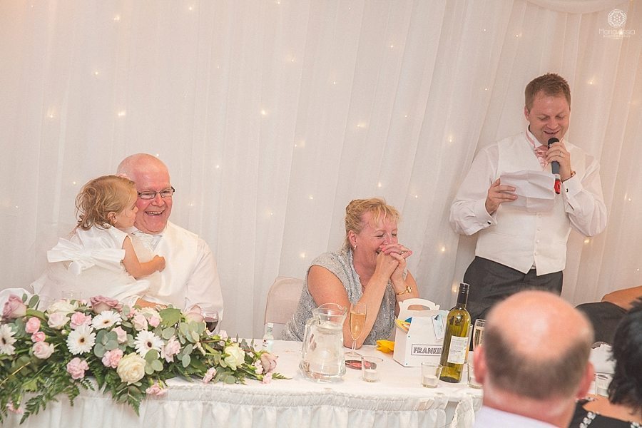 Groom's parents laughing at groom's speech