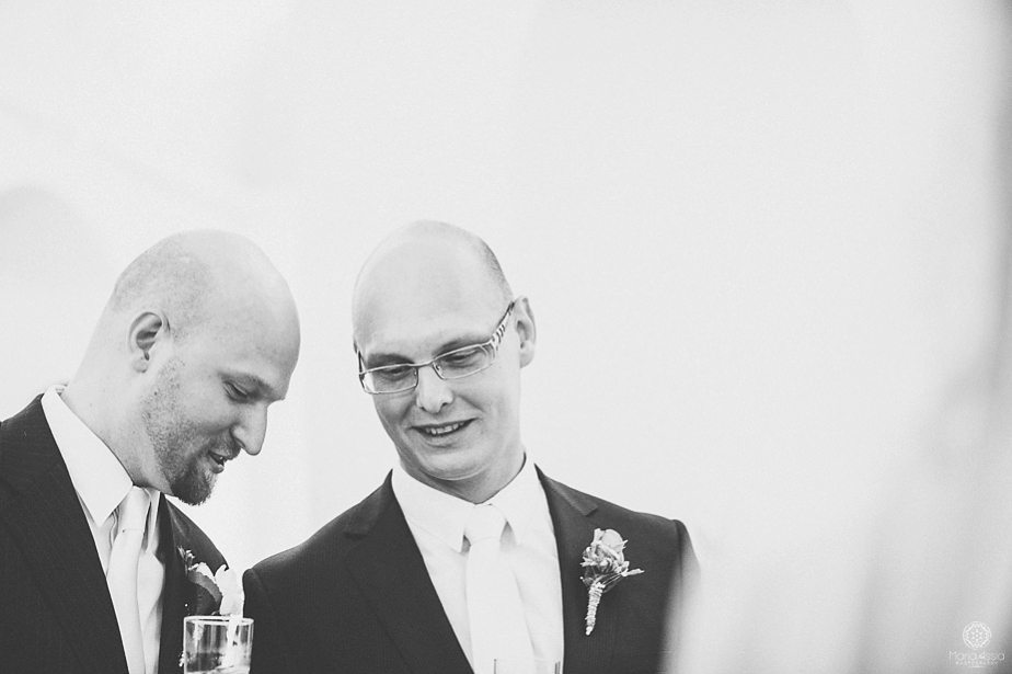 Groom chatting with his best man by destination wedding photographer Maria Assia Photography.jpg