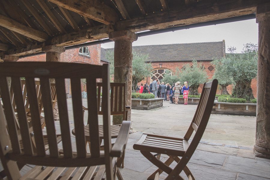 Wedding guests chatting in the grounds of Shustoke Farm Barns