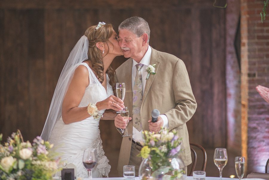 Bride kissing her father on the cheek