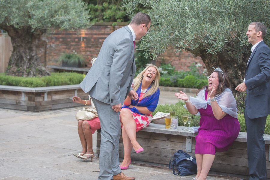 Wedding guests laughing at Shustoke Farm Barns