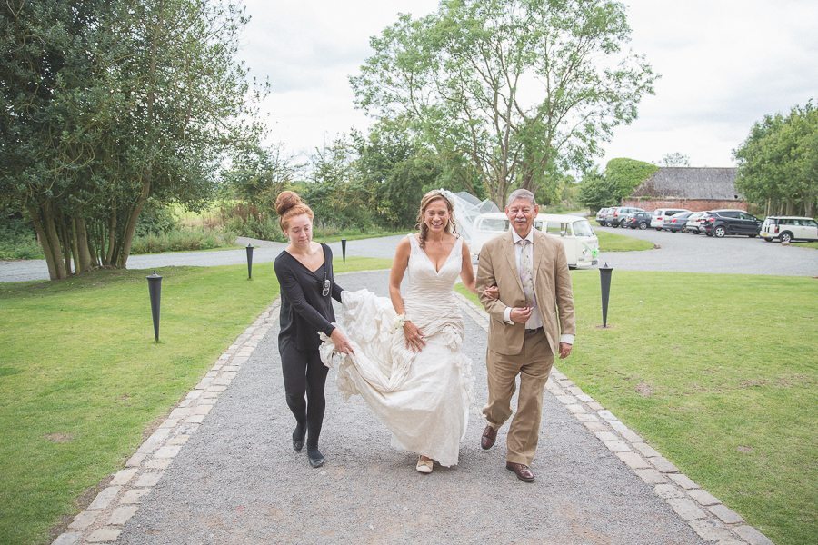 Bride arriving at her Shustoke Farm Barns wedding with her father