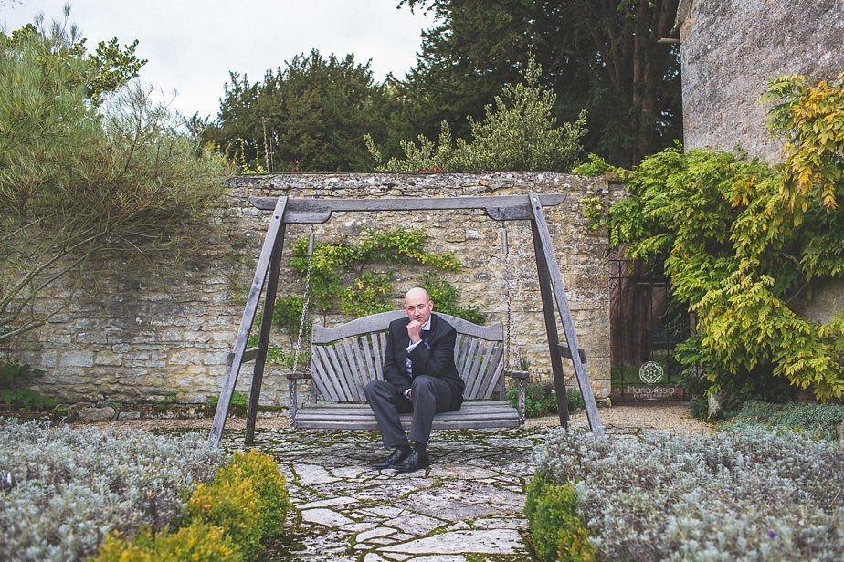 Caswell House Groom sitting on the garden swing