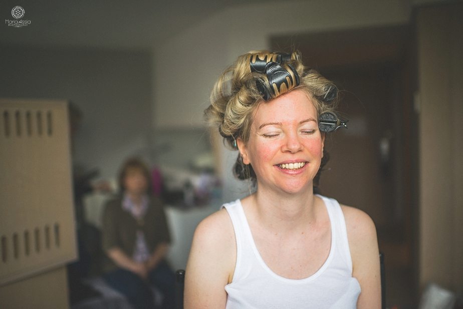 Smiling Bride with rollers in her hair