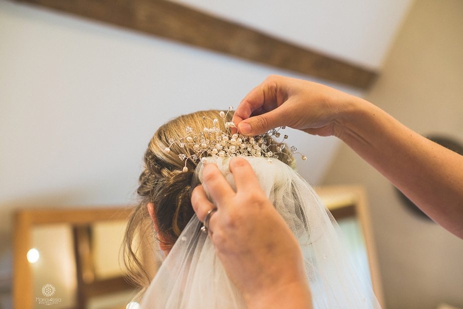 The wedding comb and veil being fitted into the bride's hair at Caswell House bridal suite