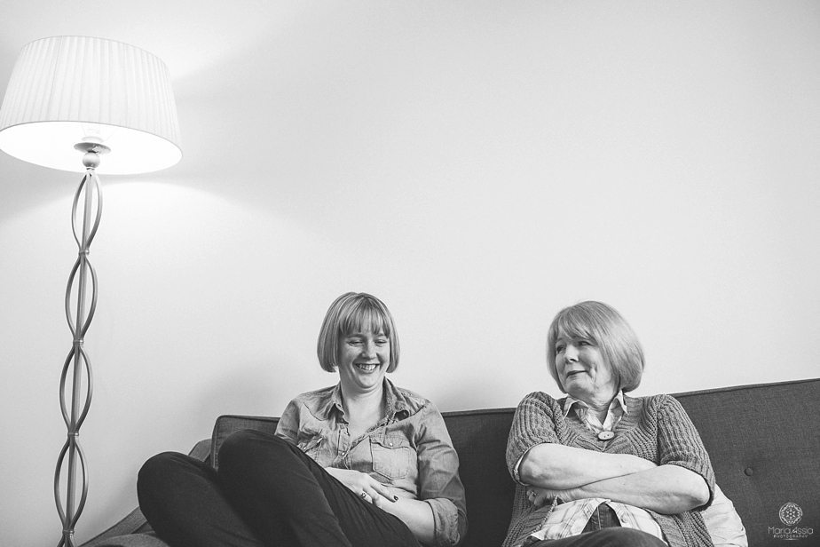 Two laughing women sitting on the couch