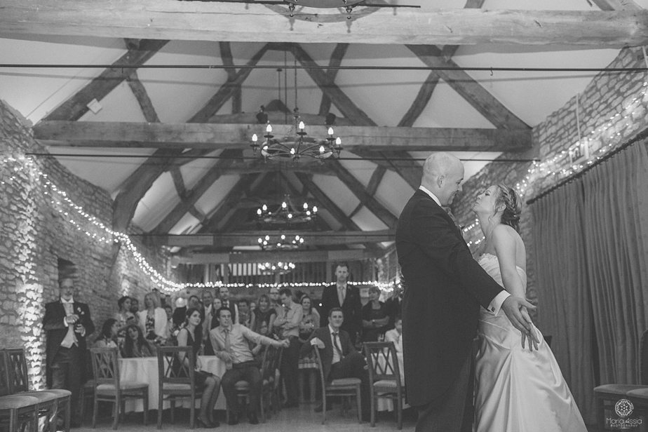 Wedding guests watching the bride and groom dancing at their Caswell House purple themed autumn wedding