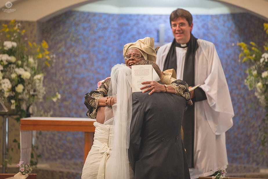 Nigerian grandmother blessing the bride and groom at their Colourful Ethnic Wedding