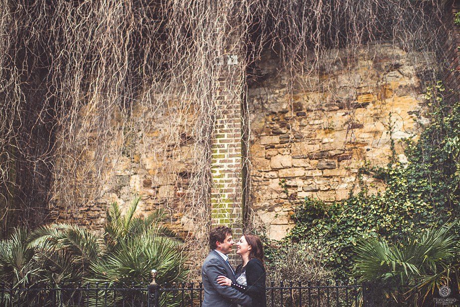 An engaged couple standing on a Hastings square on their pre wedding shoot