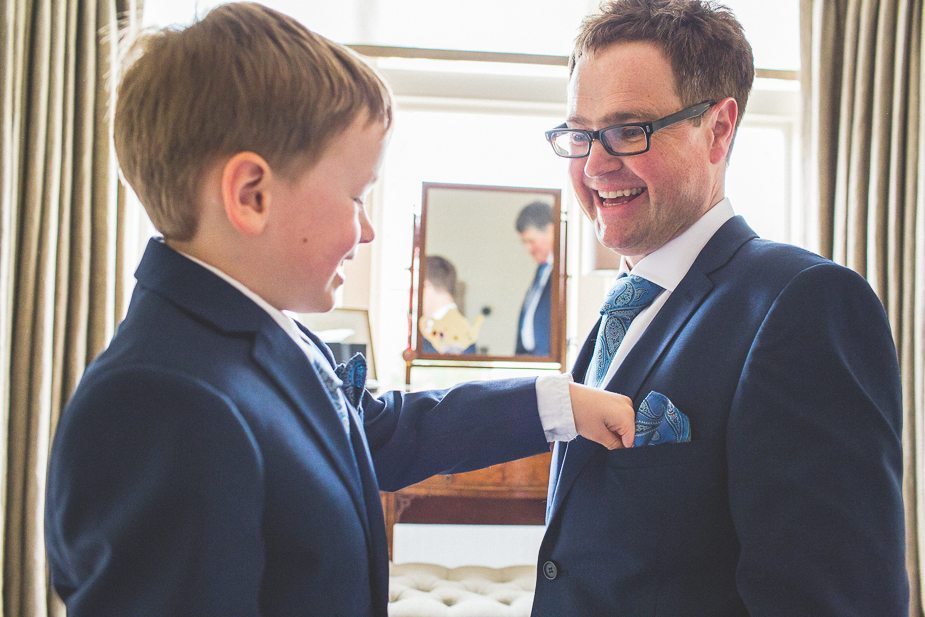 Little boy helping his dad to get ready for his wedding