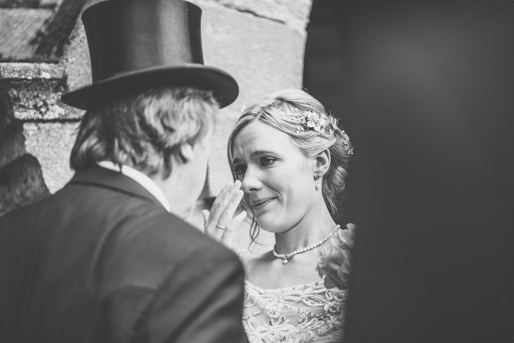 Bride crying happy tears with her dad at Coworth Park Barn summer wedding church