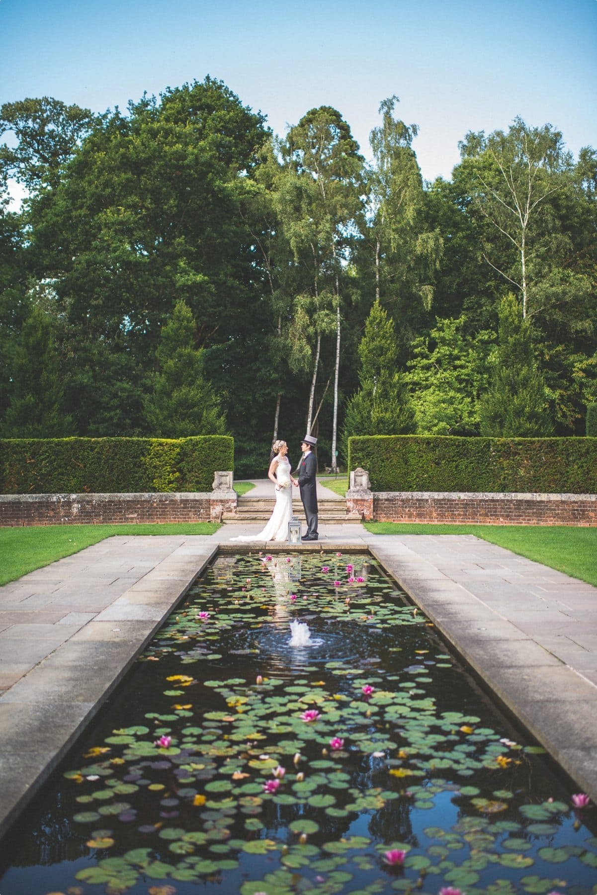 Bride and groom summer wedding portrait at coworth park lily pond awesome couple shoot location