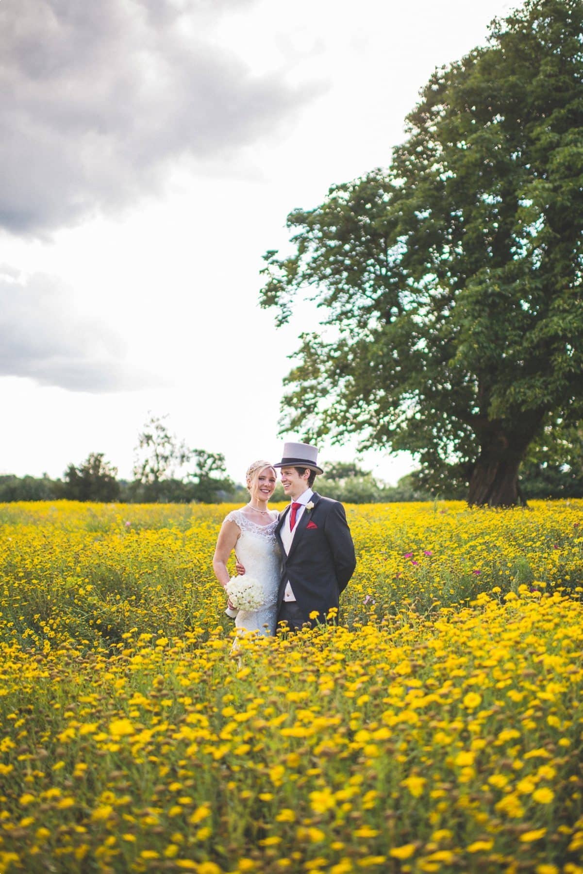 Coworth Park barn summer wedding wild flower meadow Bride and Groom portrait