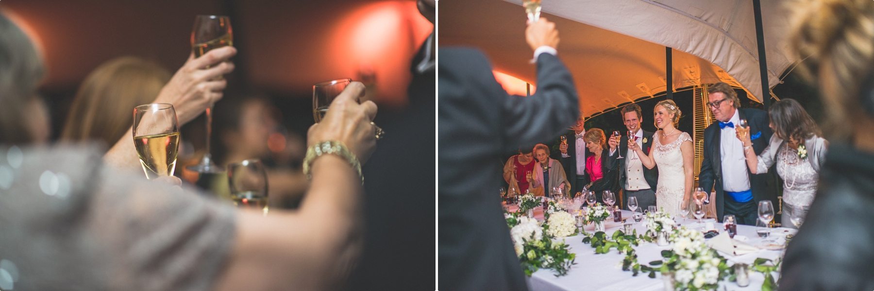 Wedding guests toasting the bride and groom at their coworth park barn summer wedding