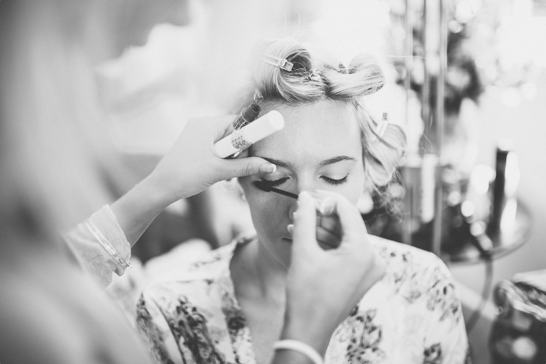 Bride's makeup being applied at Coworth Park barn wedding dower house