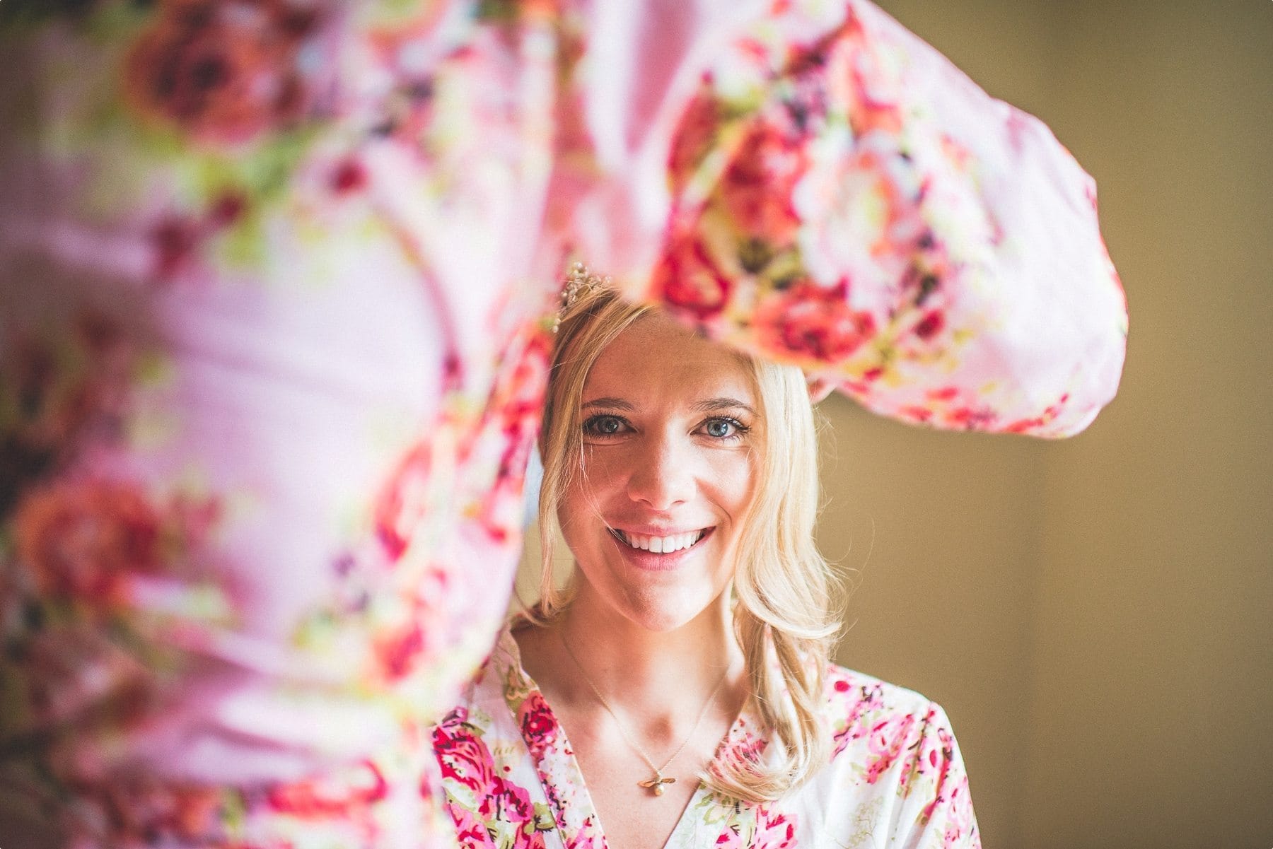 Bride smiles as she gets ready for her Coworth Park Wedding