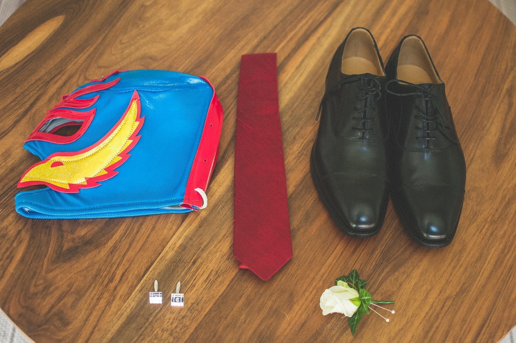 Groom's outfit and Mexican Wrestling mask laid out at coworth park barn stables