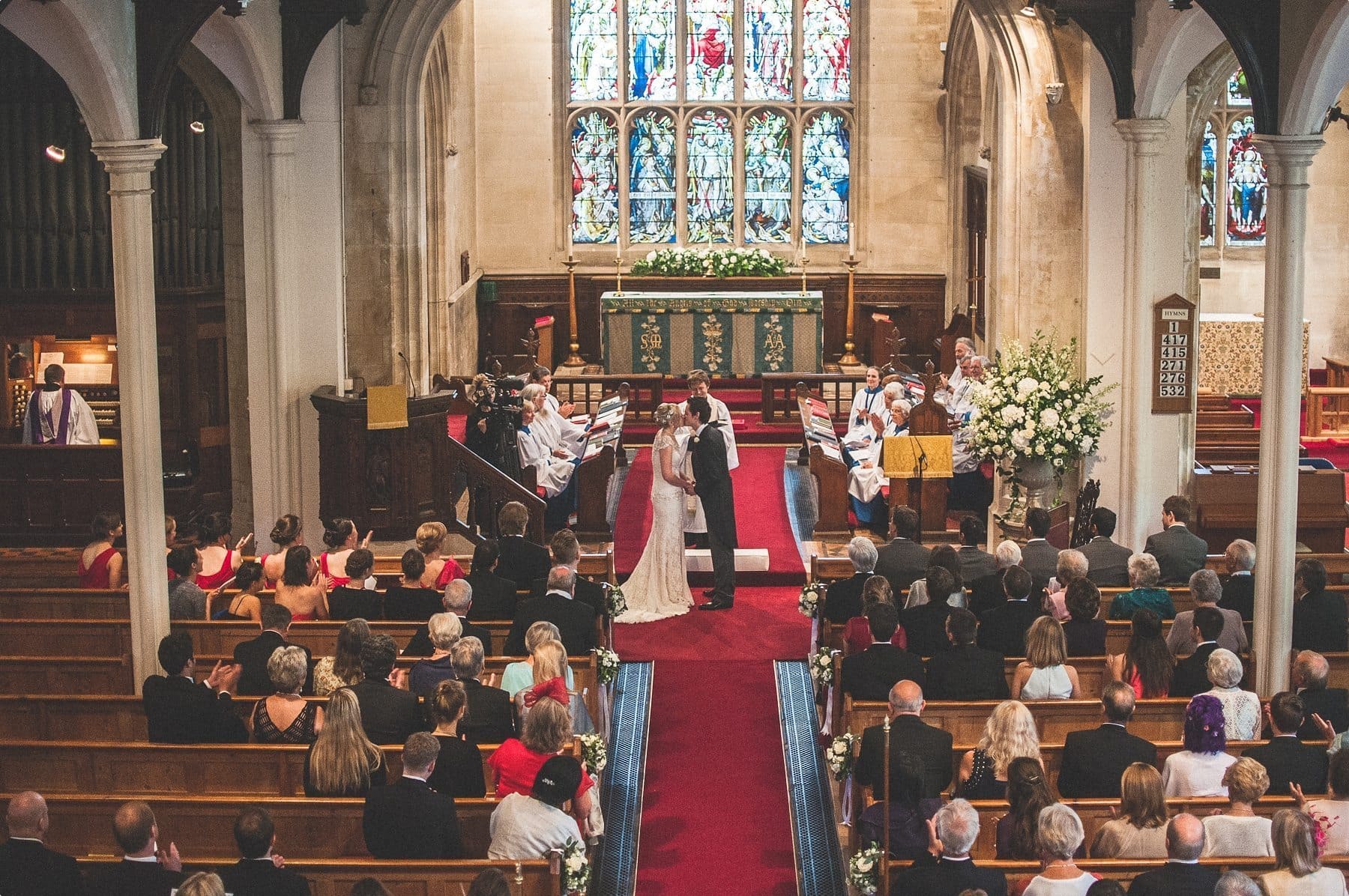 bride and groom kissing at their St Michael and all Angels church wedding ceremony