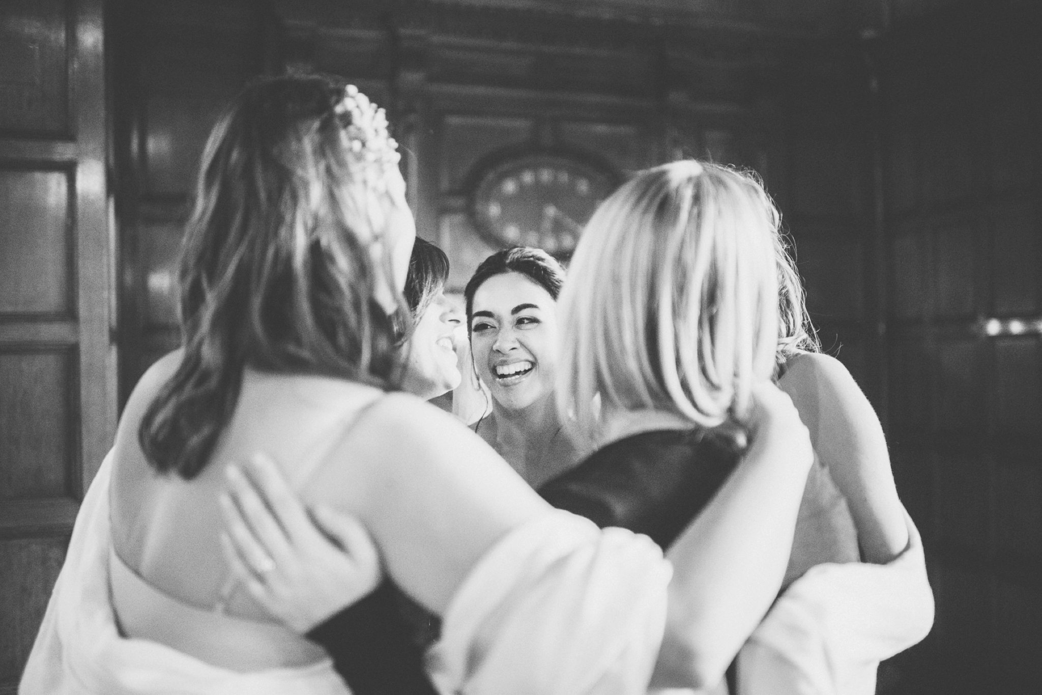 Bride hugging her bridesmaids at her Two Temple Place grand elegant London City Wedding