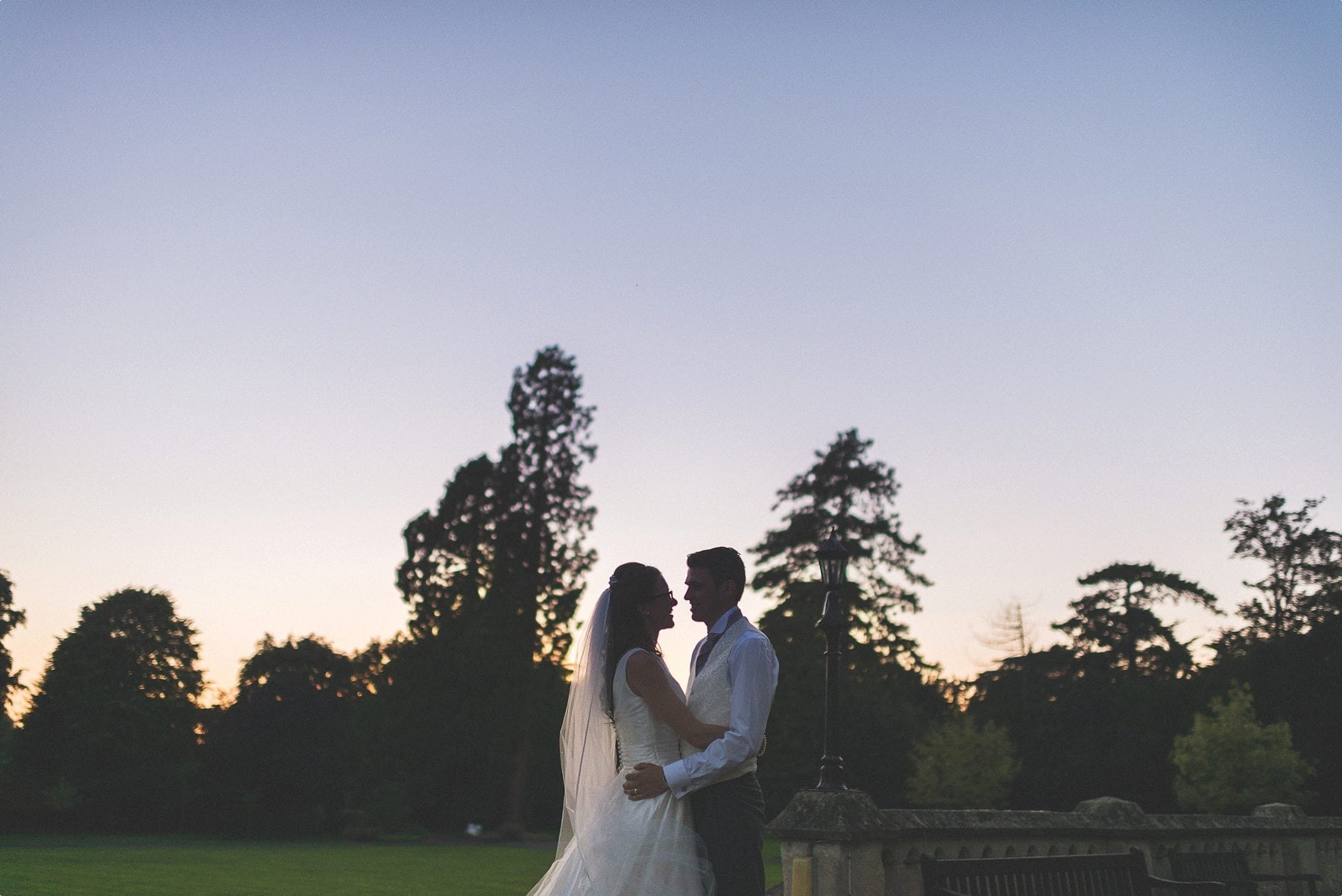 bride and groom sunset portrait at their sunbathed funfilled Horsley Towers autumn wedding