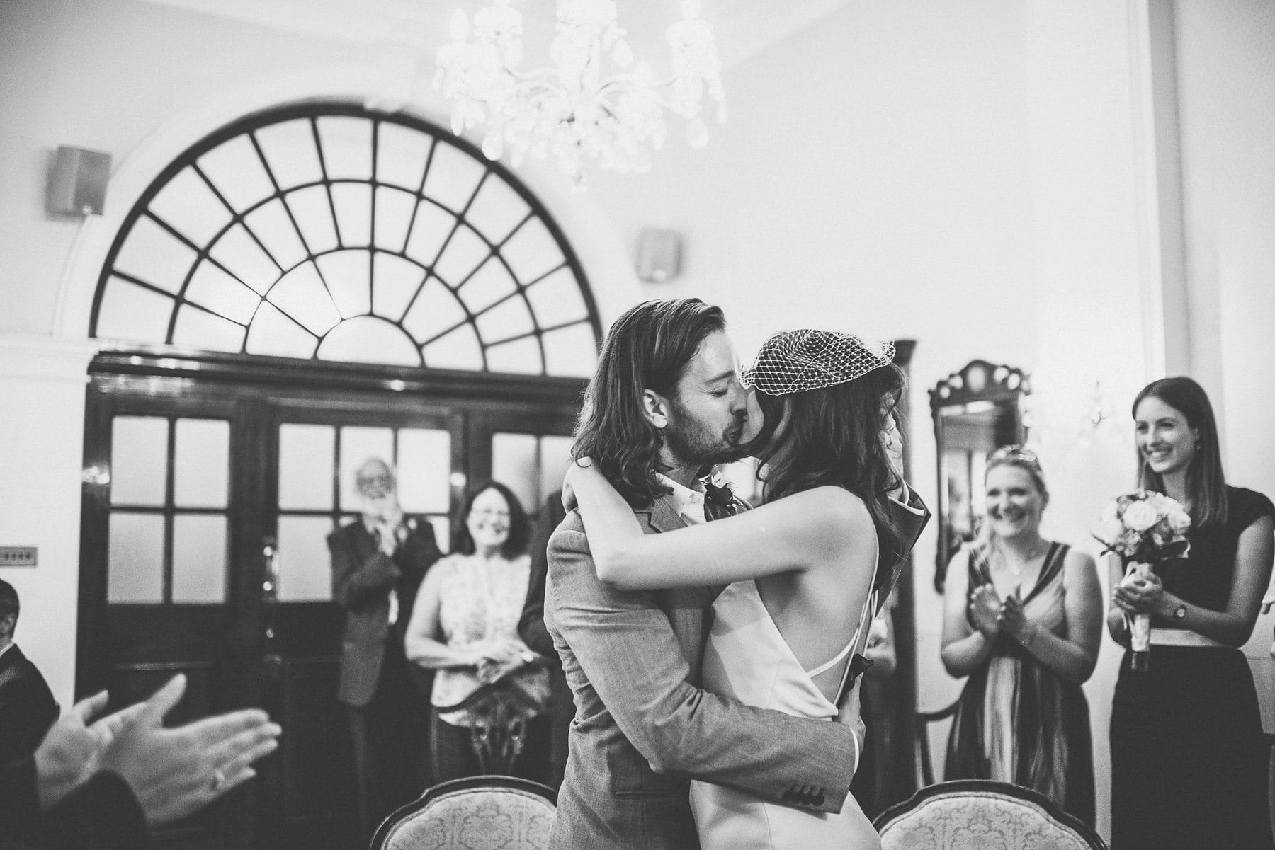 Bride and groom kissing at their Chelsea Town Hall wedding ceremony